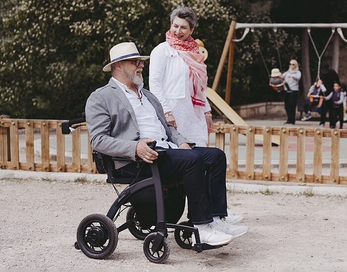 Man driving a Rollz Motion Electric wheelchair in a parc