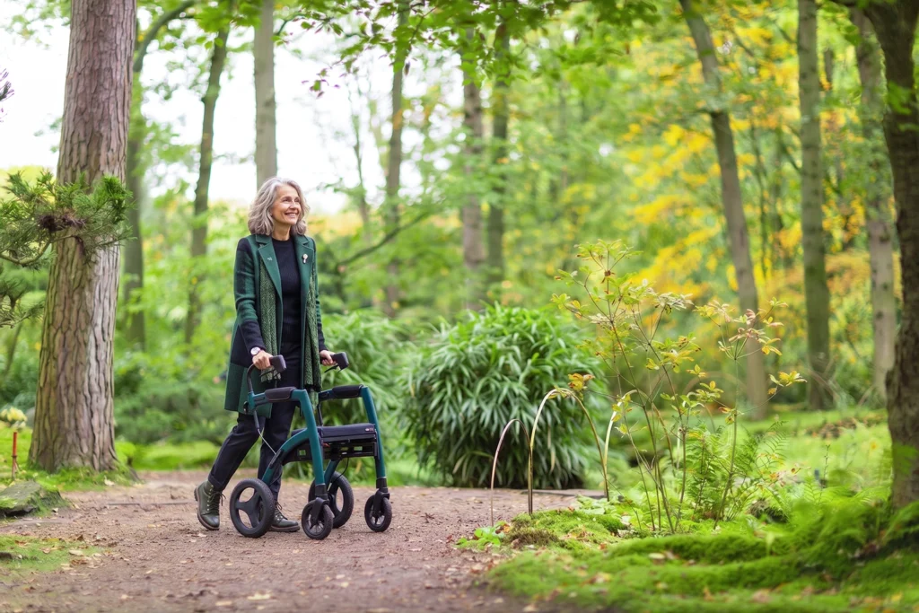 Walking through a forest with the Rollz Motion Performance all-terrain rollator